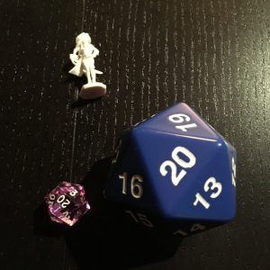 Big d20 with extra die and mini for scale