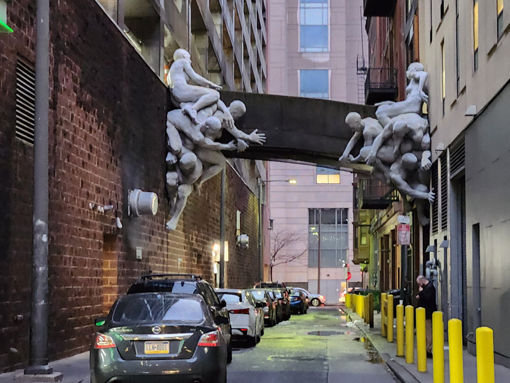 a shot of an alley in Philadelphia with statues coming out of the walls